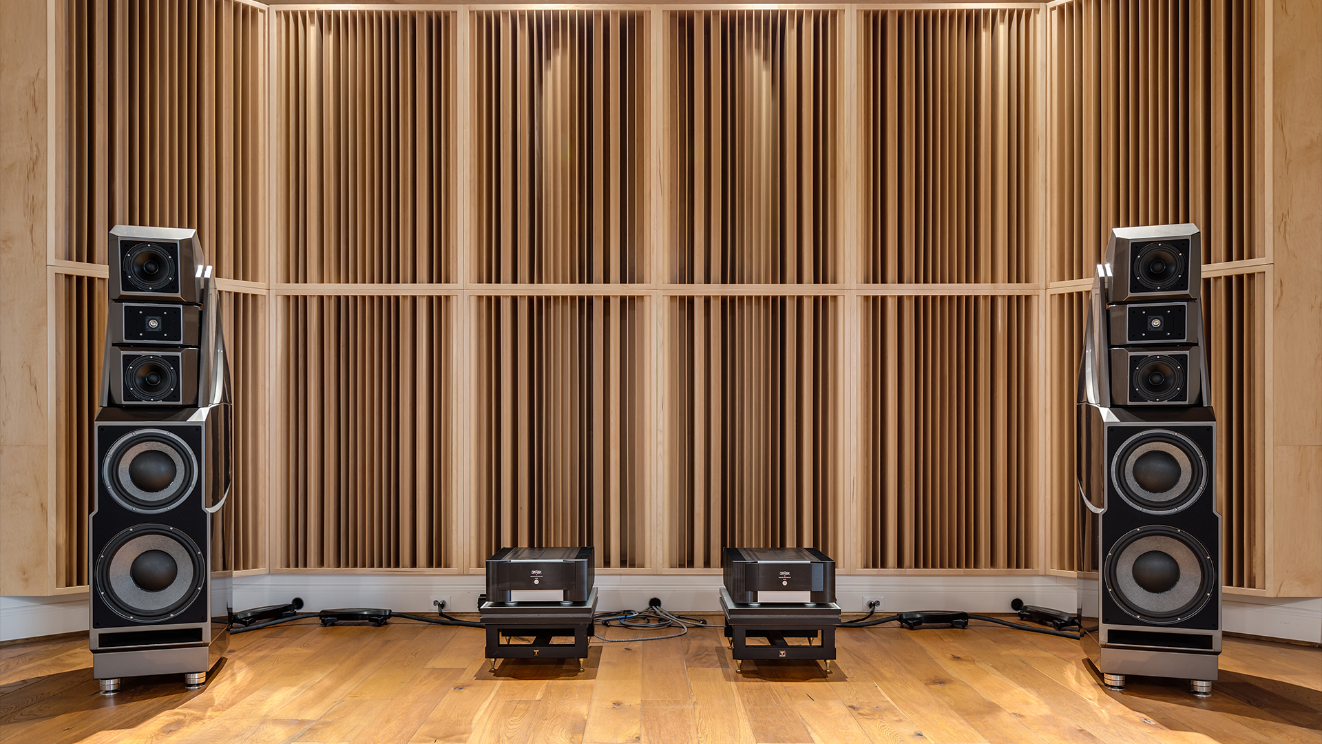 wall of acoustic sound diffusers with wilson audio speakers in front